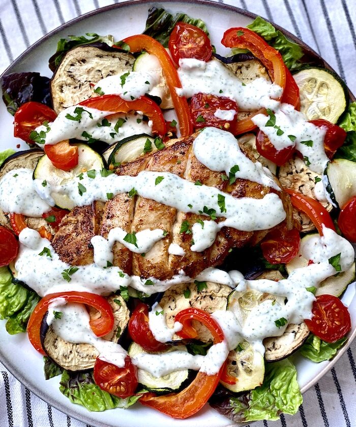 Grilled chicken and vegetables salad with garlic and mint dressing